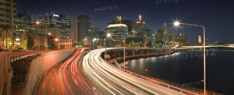 AUSTRALIA, Queensland, Brisbane, The Riverside Expressway snaking around the CBD. Car lights blurred in both directions.