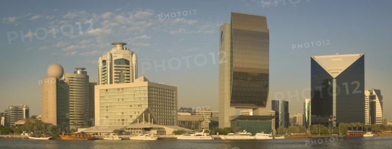 UAE, Dubai., "View of architecture along the Creek including The Etisalat Building, The Hilton, The National Bank, and The Chamber of Commerce & Industry."