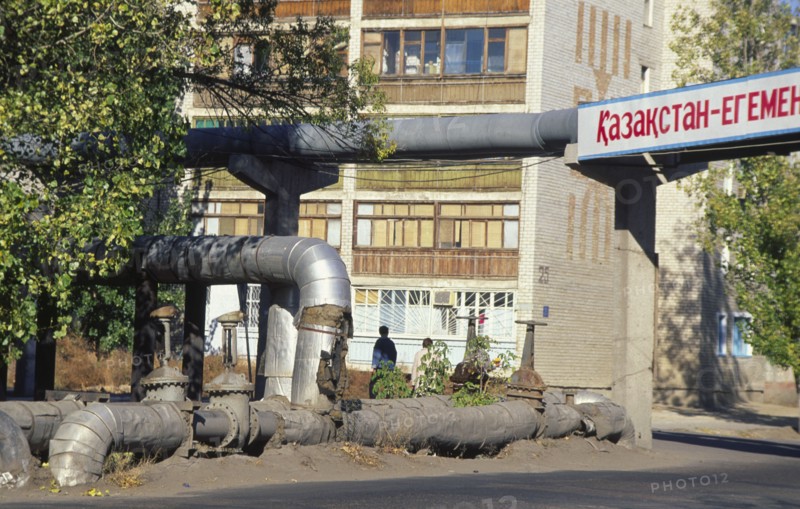 KAZAKHSTAN, Kyzlorda, Water heating pipes with apartment block behind.