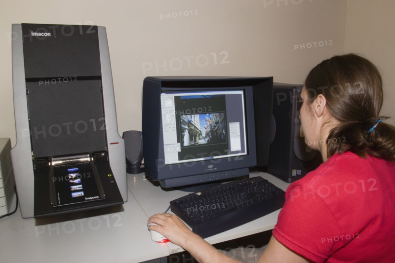 MEDIA , Film, Digital, Female technician scanning analogue slide film with an Imacon scanner