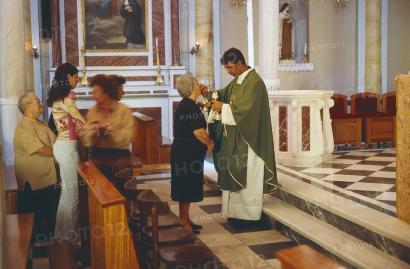 GREECE, Cyclades Islands, Syros, Ermoupolis. A Catholic service performed at the Church of Ag. Yiorgios.