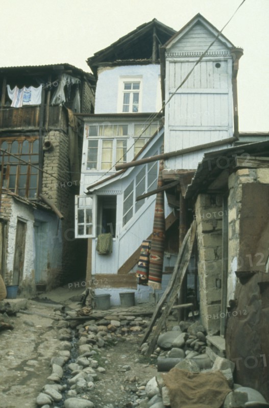 RUSSIA, Dagestan, Narrow street with central open drain and traditional housing.
