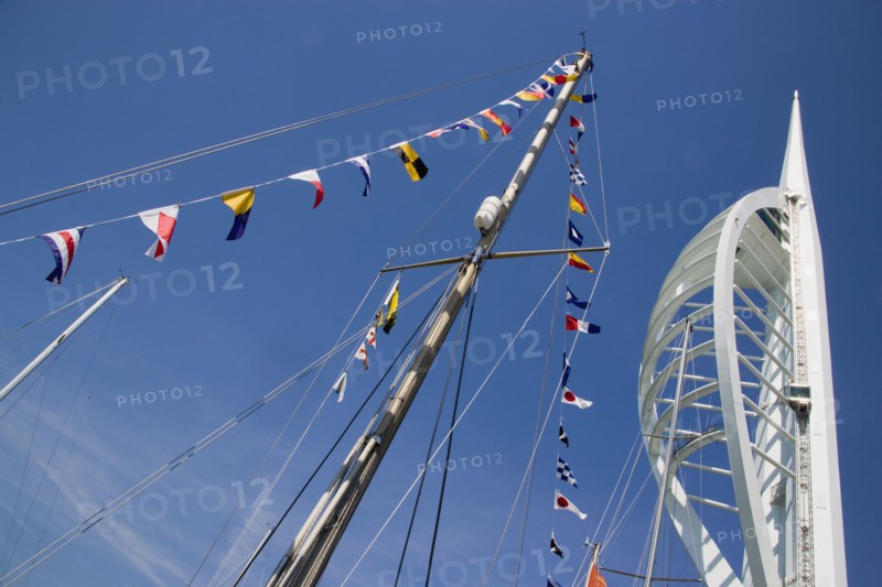 ENGLAND, Hampshire, Portsmouth, The Spinnaker Tower the tallest public viewing platforn in the UK at 170 metres on Gunwharf Quay with flags decorating a yachts rigging in the foreground