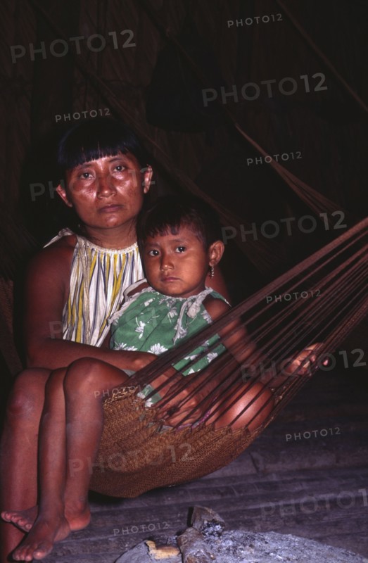 VENEZUELA, Orinoco Delta, Warao Indian woman with daughter in hammock.