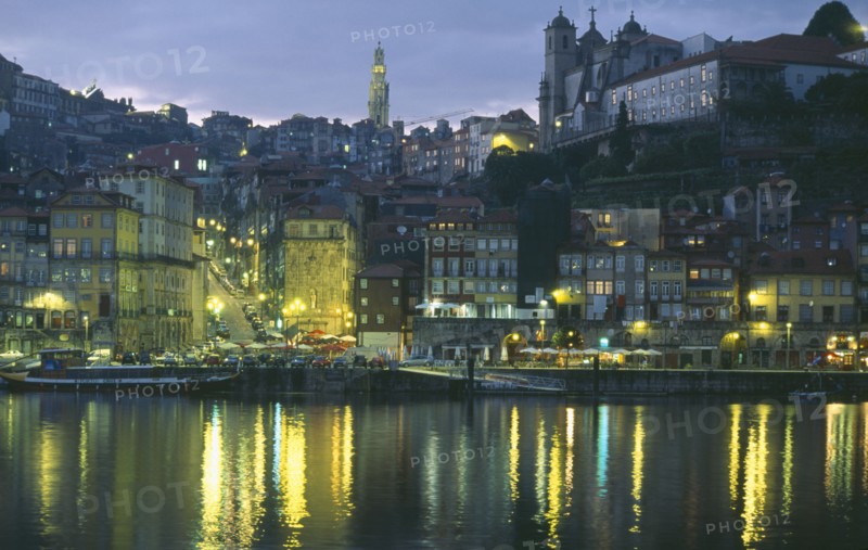 PORTUGAL, Porto, Oporto, The Ribiera and Porto at night from Vila Nova de Gaia with street lights reflected in the River Douro.