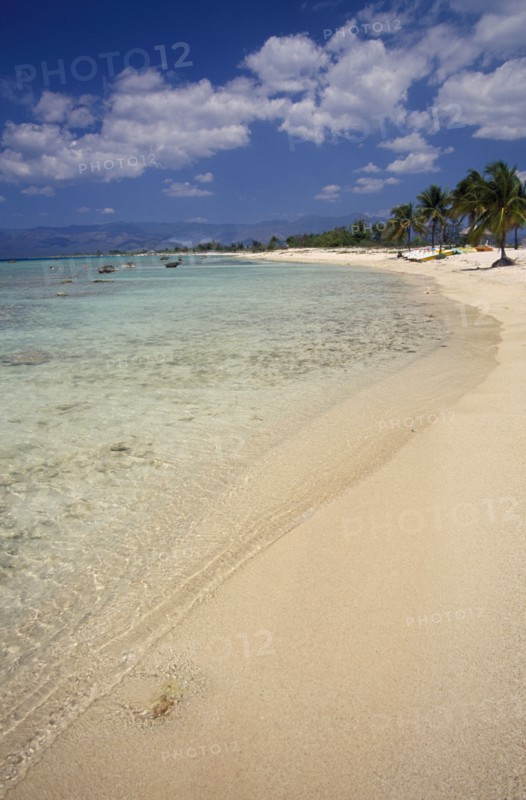 CUBA, Peninsula de Ancon, "Empty strip of sandy beach, clear shallow water and palms near Trinidad."