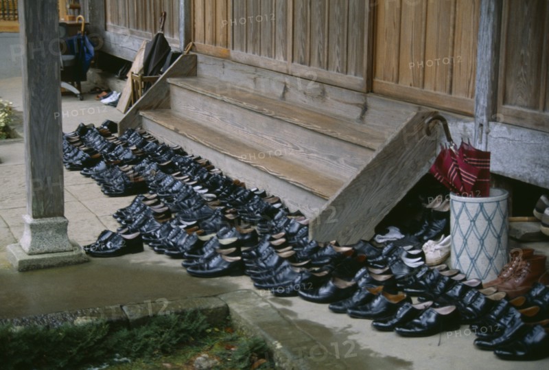 JAPAN, Buddhism, Shoes left outside steps of monastery.