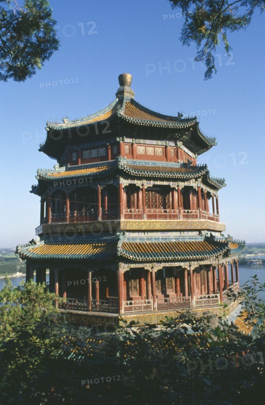 CHINA, Hebei, Beijing, The summer Palace framed by tree branches.