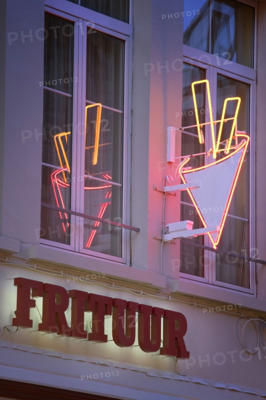 BELGIUM, Flemish Region, Antwerp, Detail of a neon chip shop sign with reflection in window.