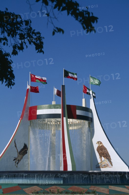 UAE, Abu Dhabi, Falcon Fountain with flags flying on top. Part of the Hotel Intercontinental