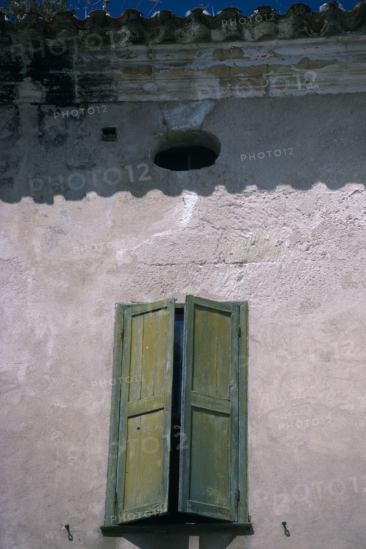 SPAIN, Balearic Islands, Menorca, Mahon.  Detail of house facade with green window shutter in Plaza Colon.