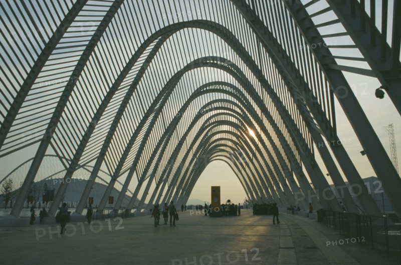 GREECE, Central, Athens, Olympic Stadium. People wandering through the walkway covered with arches in the evening.