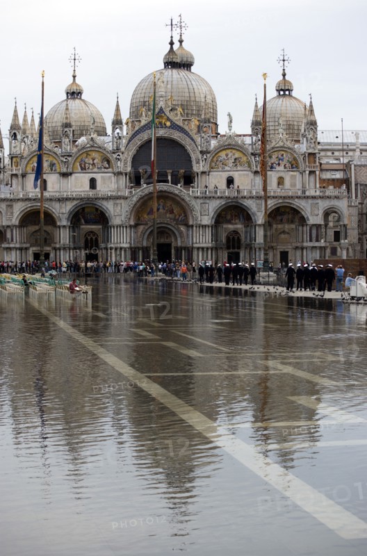 ITALY, Veneto, Venice, Aqua Alta High Water flooding in St Marks Square showing St Marks Basilica at the end of the flooded piazza