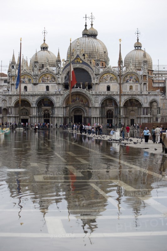 ITALY, Veneto, Venice, Aqua Alta High Water flooding in St Marks Square showing St Marks Basilica at the end of the flooded piazza