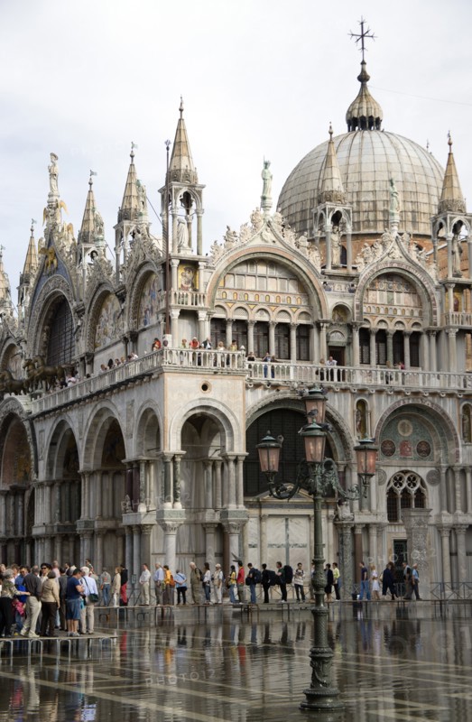 ITALY, Veneto, Venice, Aqua Alta High Water flooding in St Marks Square with tourists walking on elevated walkways above the water beside St Marks Basilica Paul Seheult