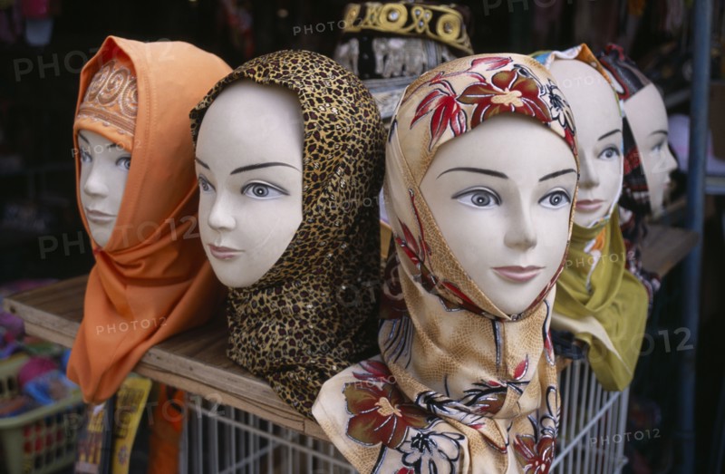 ISRAEL, Acre, Arabic mannequin heads displaying an array of different headscarves for sale on shop stall