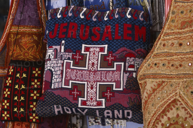 ISRAEL, Jerusalem, Old City. Detail of a handmade tourist bag decorated with the words Jerusalem Holy Land and an orthodox Christian Cross