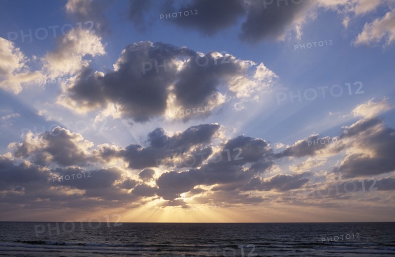 ISRAEL, Landscape, Sunset  with the sun behind a dramatic cloud formation over the Mediterranean Sea