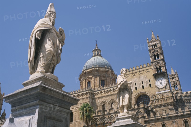 ITALY, Sicily, Palermo, II Duomo Cathedral exterior with religious statues and section of domed roof and clock behind