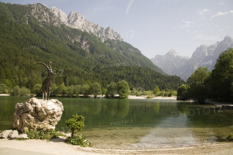 SLOVENIA , Kranjska Gora, Julian Alps, The famous Ibex statue at Lake Jasna just a ten minute walk form the centre of the town at the entrance to Velika Pisnica near the road to Vrsic Mountain Pass with Mounts Razor and Prisank in the background