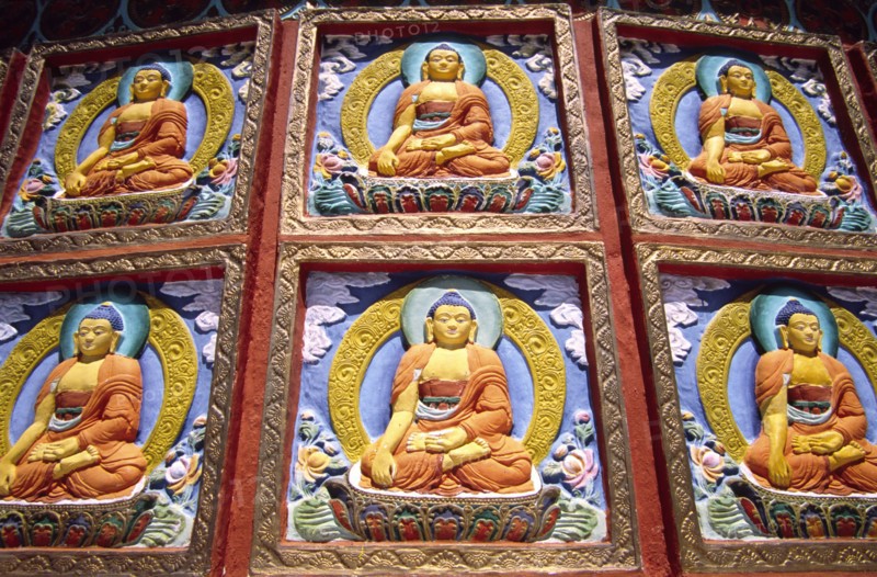 INDIA, Ladakh, Leh, "Shanti Stupa Buddhist reliefs. Leh's most prominent Buddhist landmark is a gleaming white shrine perched on a ridge above the town. Conical in shape, the stupa has several levels, each accessible by stairways. Ritual circumambulation of these levels reveals a wealth of religious art"