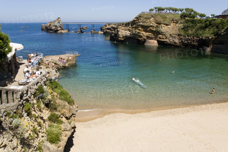 FRANCE, Aquitaine Pyrenees Atlantique, Biarritz, The Basque seaside resort on the Atlantic coast. The Plage de Port-Vieux with a seafood restaurant on a promontory at the end of the beach and the Rocher de la Vierge out to sea