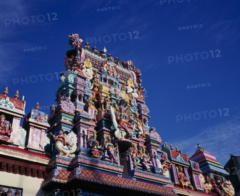 MALAYSIA, Penang, Georgetown, Sri Mariamman Temple.  Angled part view of exterior and gopuram painted tower decorated with brightly painted figures of Hindu gods and characters.