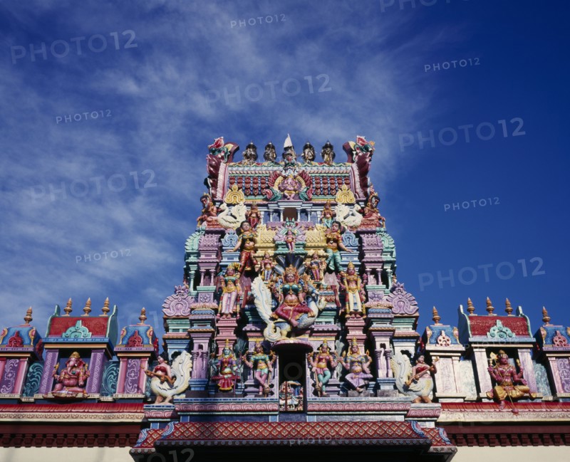 MALAYSIA, Penang, Georgetown, Sri Mariamman Temple.  Part view of exterior roof and gopuram painted tower decorated with brightly painted figures of Hindu gods and characters.