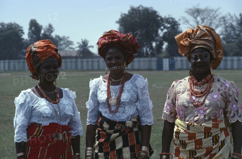 NIGERIA, People, Three-quarter portrait of three Ibo women dressed in traditional clothes for special occasion.