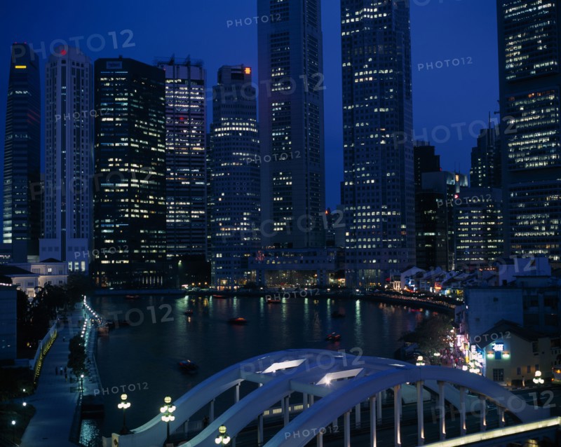 SINGAPORE, General, Singapore River basin and city skyline at night with lights from waterfront buildings reflected in water.