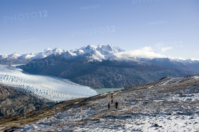 CHILE, Southern Patagonia, O'Higgins region , "Trekers walking in O'Higgins region of Patagonia, with O'Higgins Glacier in the background. Trek from Glacier Chico (Chile) to El Chalten (Argentina) "
