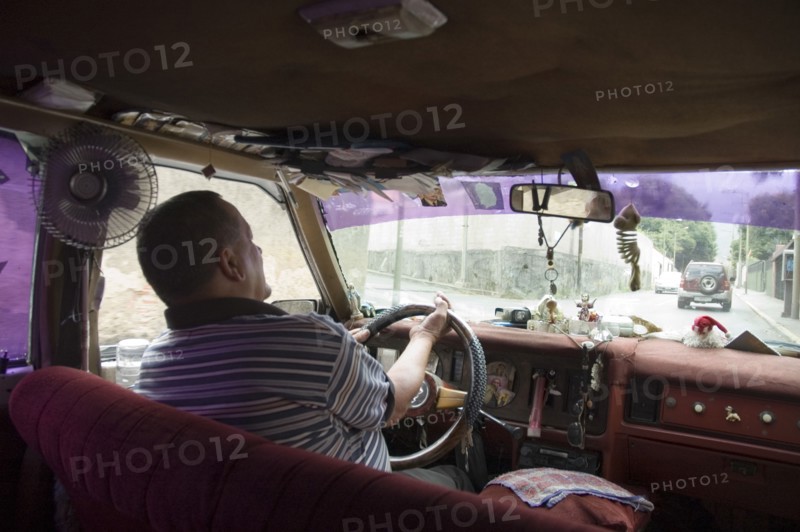 VENEZUELA, Caracas , Passenger seat view of a Caracas taxi including ventilation fan and dash-board ornaments