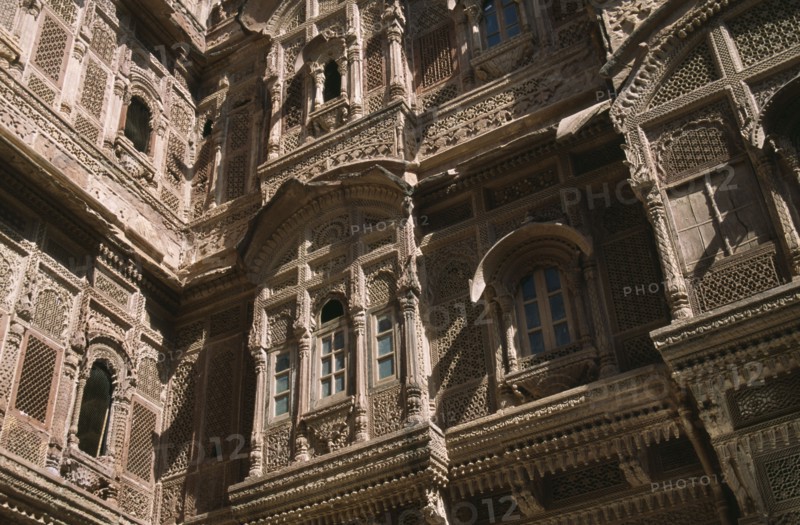 INDIA, Rajasthan, Jaisalmer, Patwon-ki-Haveli 1800-1860.  Sandstone house of wealthy merchant.  Part view of highly decorated exterior facade.