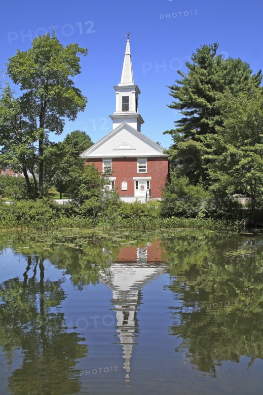USA, New Hampshire, Harrisville, Community church refelected in pond.