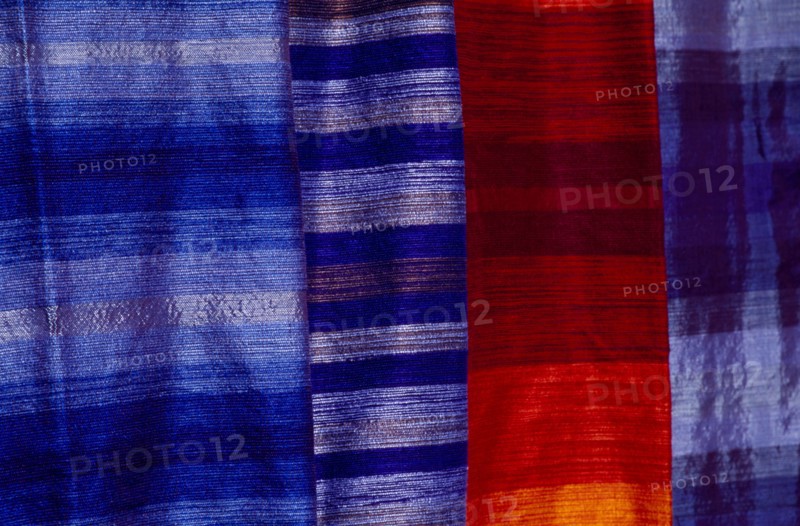 MOROCCO, Essaouira, Detail of red and blue woven textiles.