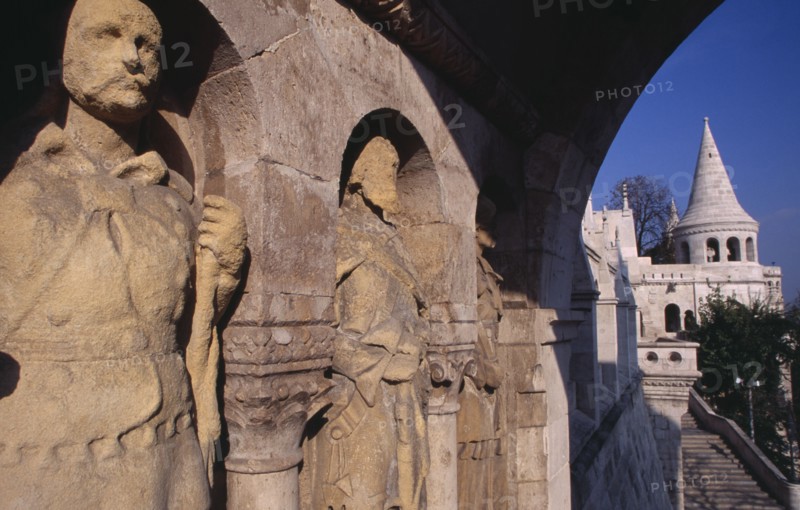 HUNGARY, Budapest, Carved stone figures lining archway with Fishermen s Bastion. Eastern Europe