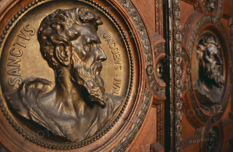 HUNGARY, Budapest, Basilica of St Stephen.  Detail of door with bronze relief carvings of the heads of the twelve apostles. Eastern Europe