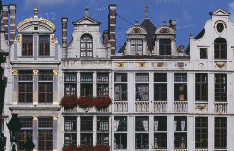 BELGIUM, Brabant, Brussels, Part view of building facades with gable rooftops and gilded decoration  balconies and flower filled window boxes.