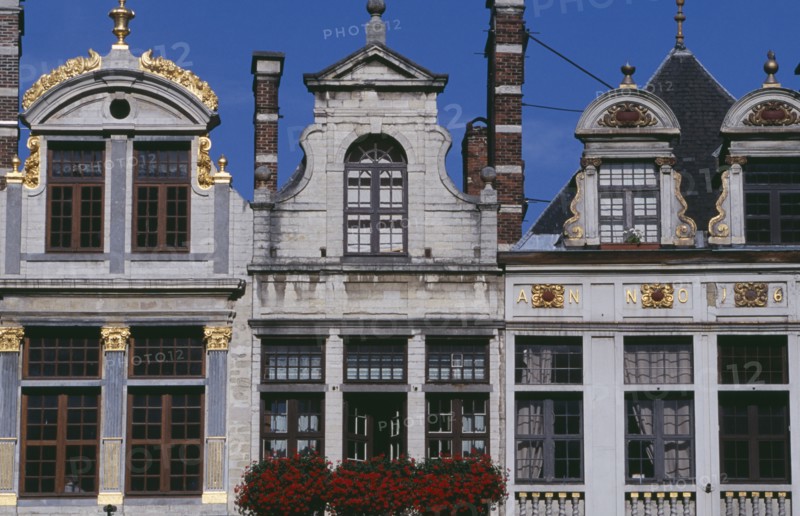 BELGIUM, Brabant, Brussels, Part view of building facades with gable rooftops and gilded decoration  balconies and flower filled window boxes.