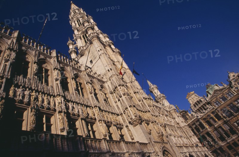BELGIUM, Brabant, Brussels, The Grand Place.  Hotel de Ville.  Angled view of exterior facade decorated with statues representing the Dukes and Duchessess of Brabant.