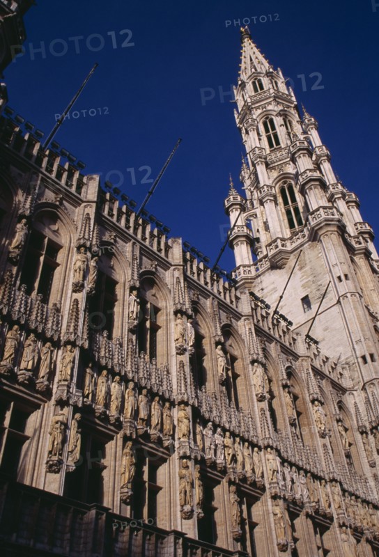 BELGIUM, Brabant, Brussels, The Grand Place.  Hotel de Ville.  Angled view of exterior facade decorated with statues representing the Dukes and Duchessess of Brabant.