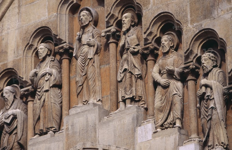 HUNGARY, Budapest, Benedictine Abbey of Jak. Detail of carved religious figures over stone archway.