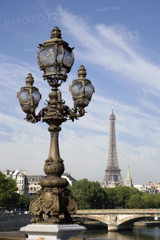 FRANCE, Ile de France, Paris, Art Nouveau lamp-post on Ponte Alexandre III bridge across the River Seine named after Tsar Alexander III of Russia with the Eiffel Tower in the distance