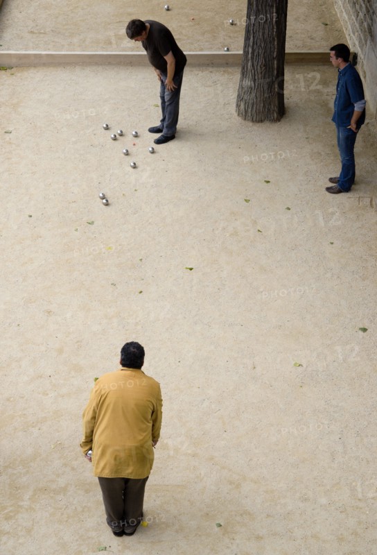 FRANCE, Ile de France, Paris, "Three men playing Boules, or Petanque, beside the River Seine"