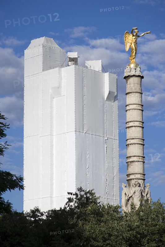 FRANCE, Ile de France, Paris, Les Halles. A gilded statue on top of a column in Place du Chatelet with the Tour St Jacques under scaffolding and fabric beyond whilst undergoing restoration