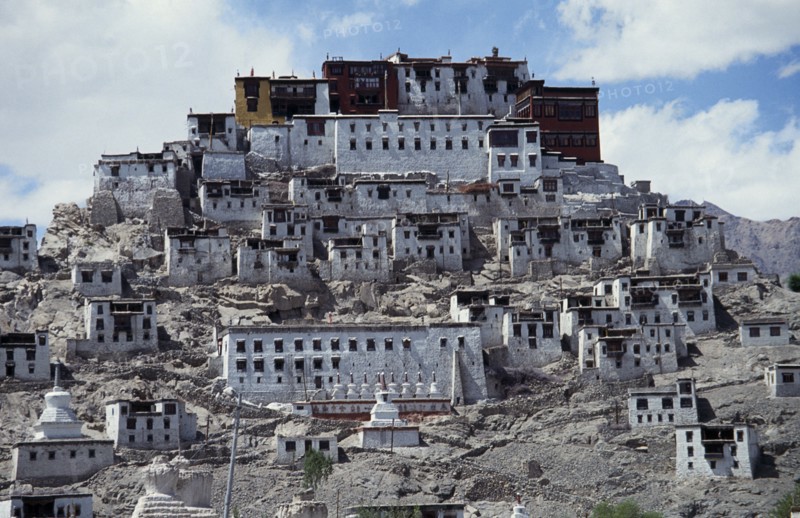 INDIA, Ladakh, Tikse Gompa, Tibetan Buddhist monastery and surrounding buildings set into steep hillside.
