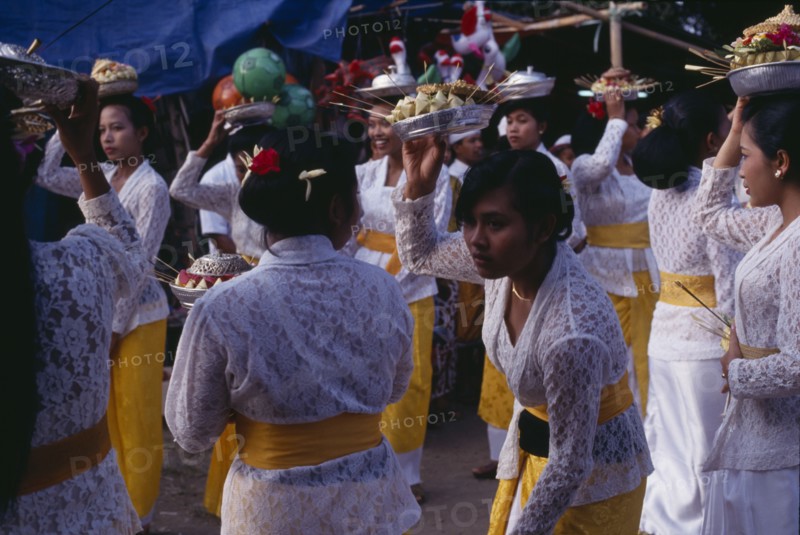 INDONESIA, Bali, Religion, Procession of women carrying food offerings to temple on occasion of temple birthday festival.