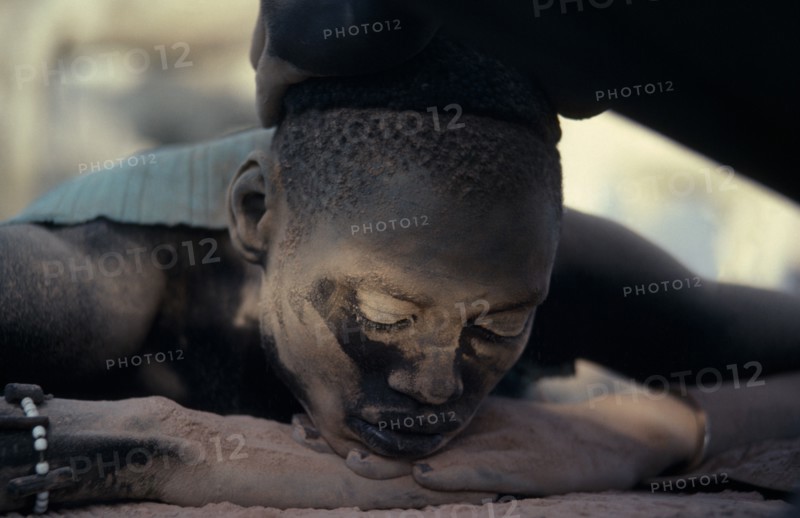 SUDAN, Rumbek, Dinka youth having hair bleached with cattle urine in Majak Asok cattle camp.