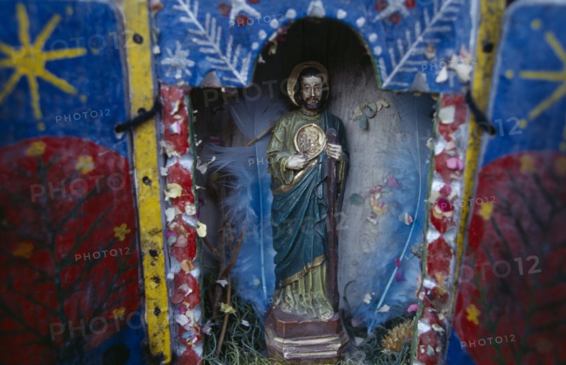 ECUADOR, Religion, Icon, Religious statuette in blue painted shrine with feathers in coloured paper.