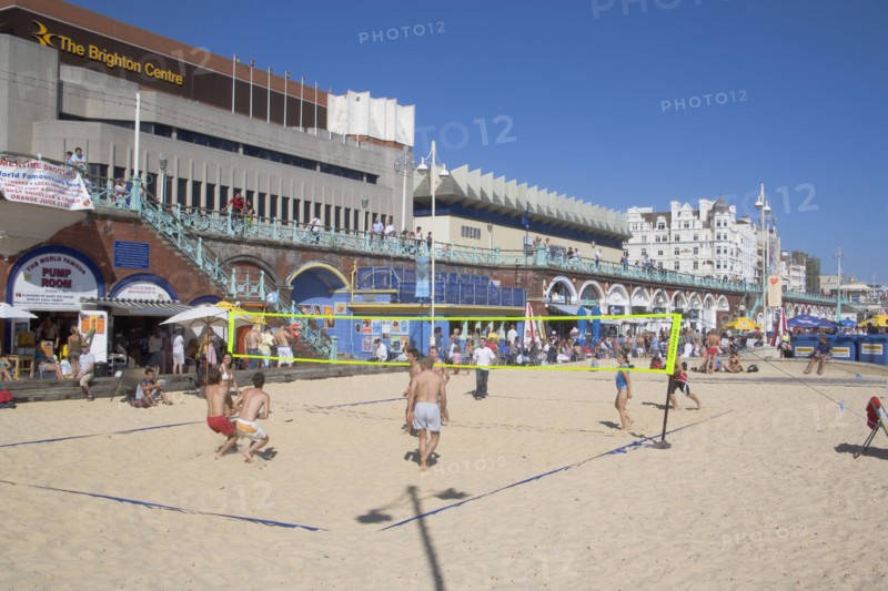 ENGLAND, East Sussex, Brighton, People playing beach volleybal on the sands in front of the Brighton Centre.